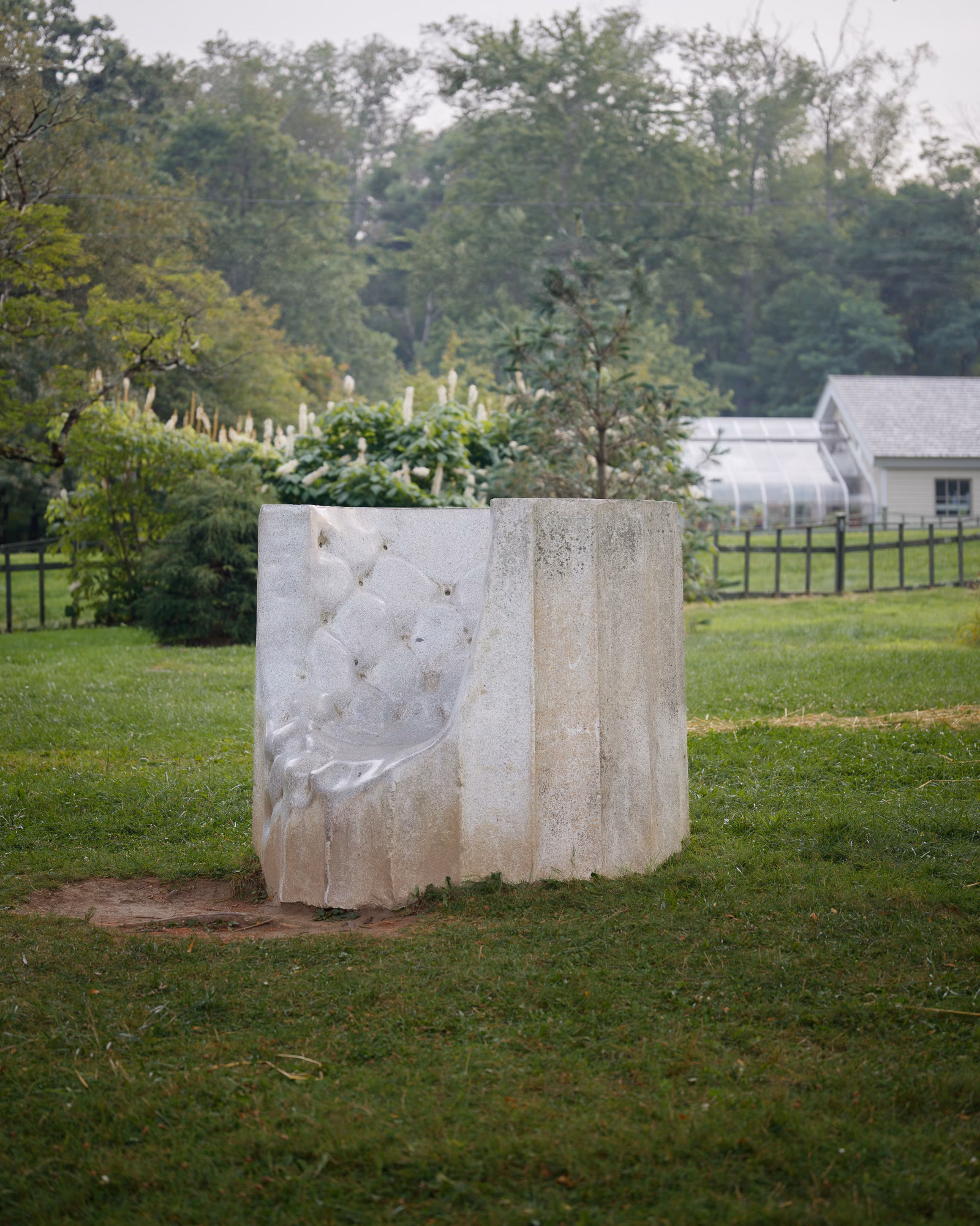 Outdoor fabric sculpture installation on green lawn with trees