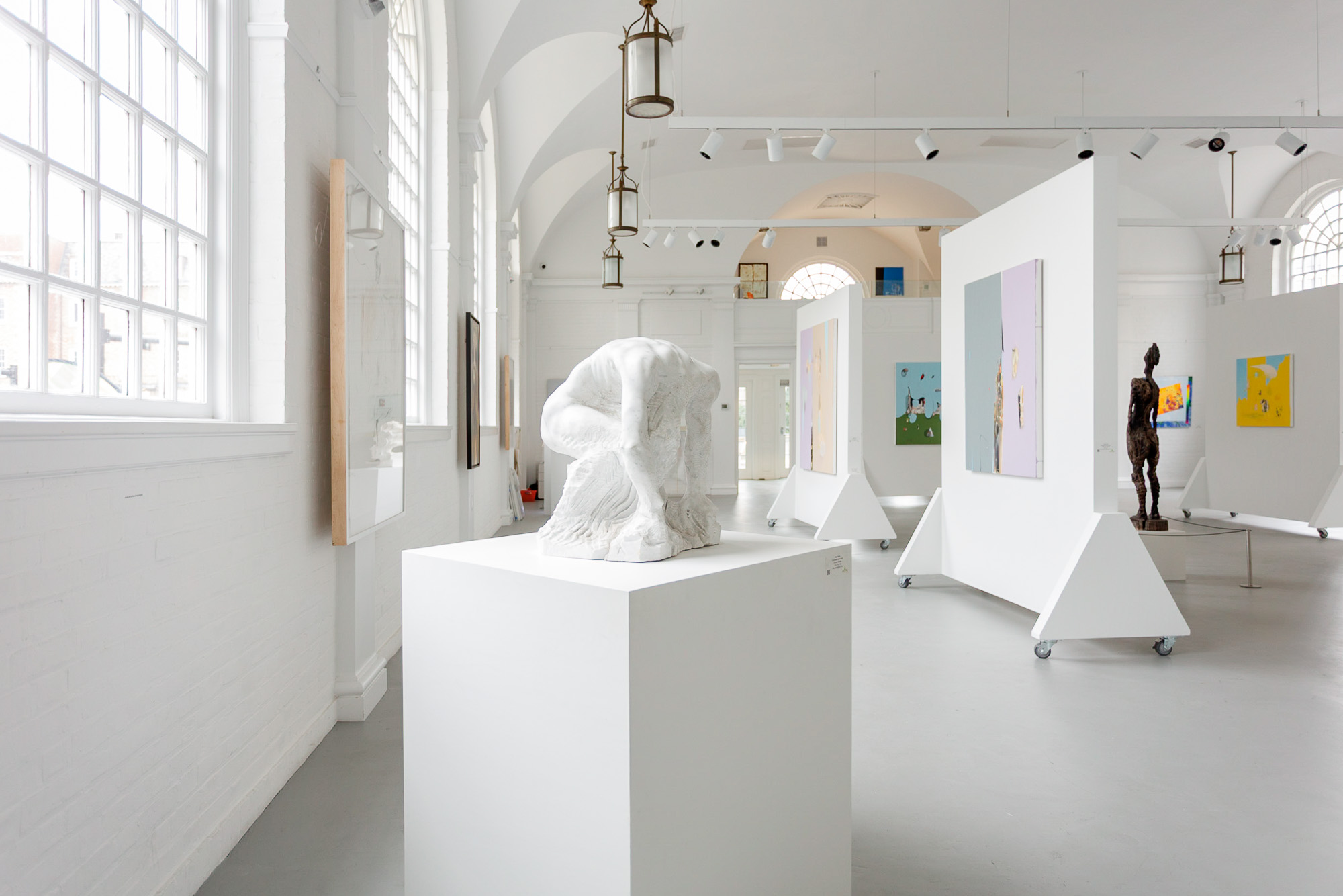 Large hanging glass and bead sculpture installation in white gallery space